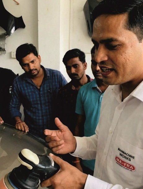 Trainer mastering the craft of car detailing